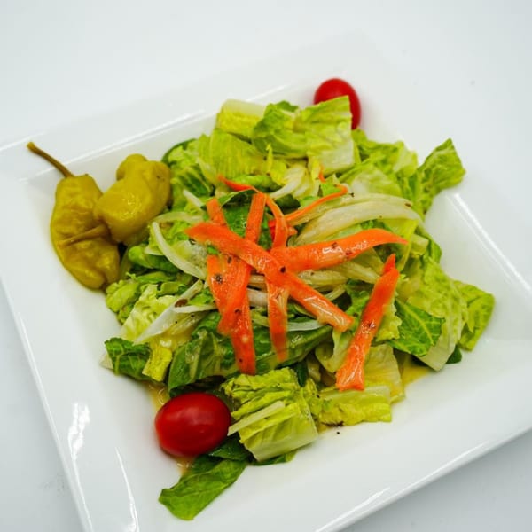 Antonella's Pizzeria house salad with lettuce, carrots, onions, cherry tomatoes, and banana peppers.