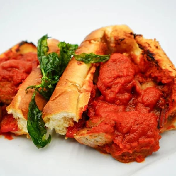 Antonella's Pizzeria's meatballs and marinara sauce served in a toasted baguette with fresh basil.